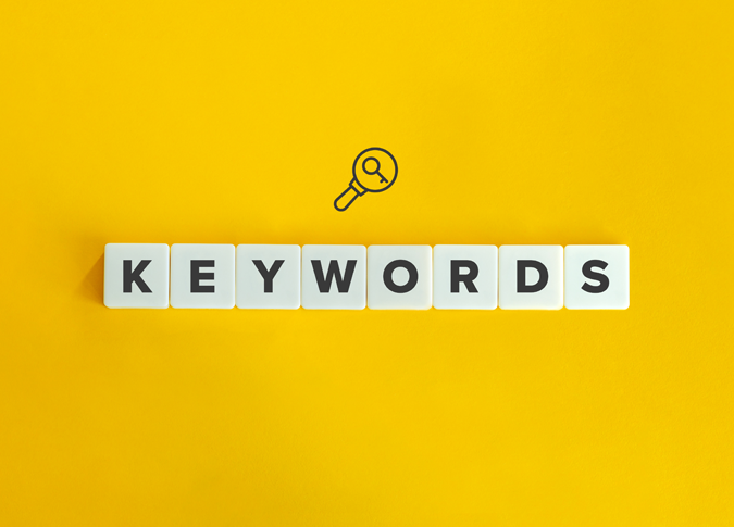 letter tiles spelling out the word, "keywords" on a bright yellow background