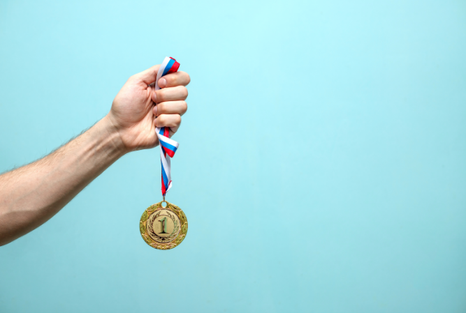 arm holds gold medal