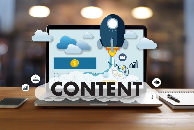photo of a laptop on a desk with illustrated 'content' on the screen