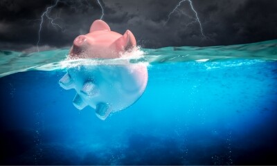 a piggy bank floats in choppy waters during a storm