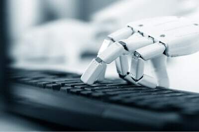 robot hand a robotic hand typing on a keyboard