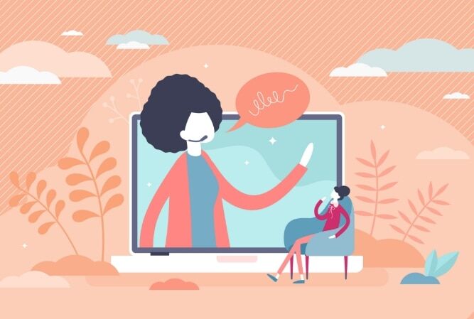 a woman sits in front of a laptop with a video of someone speaking playing