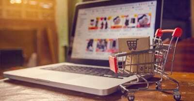 mini shopping cart in front of laptop