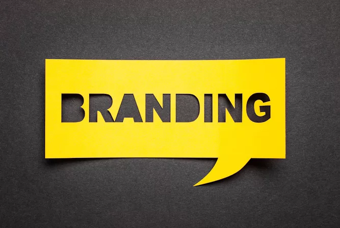 Yellow speech bubble with the word branding cut out over a black background.