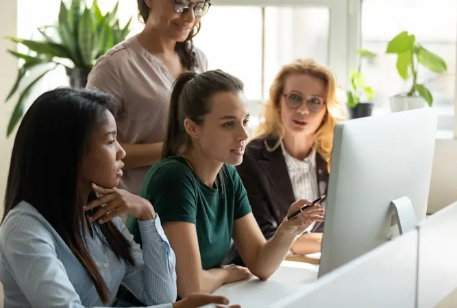 women meeting around computer