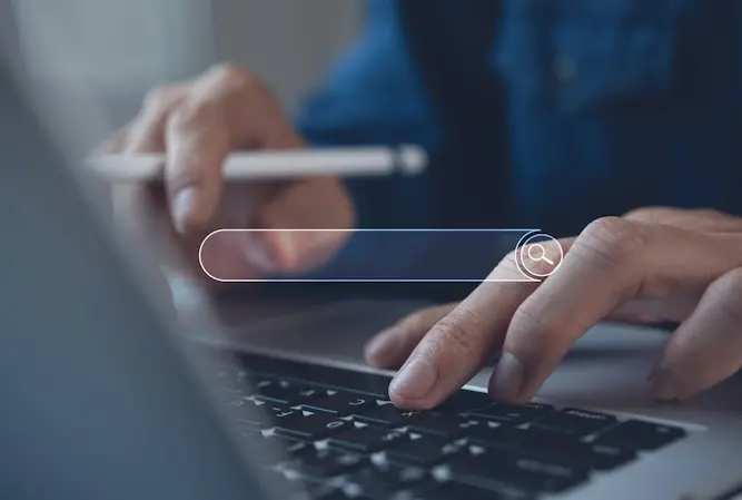 close up of man searching online on laptop