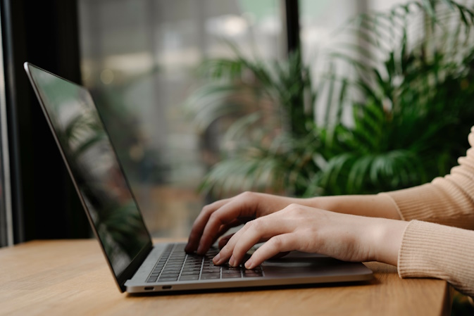 copywriter typing on laptop