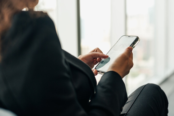 woman scrolling social media on her phone