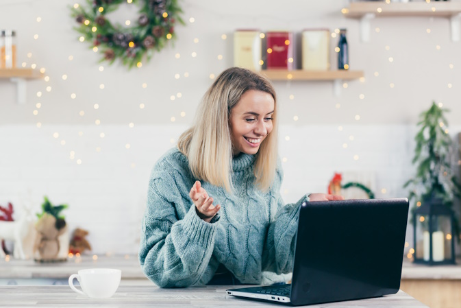 woman working on computer during christmas